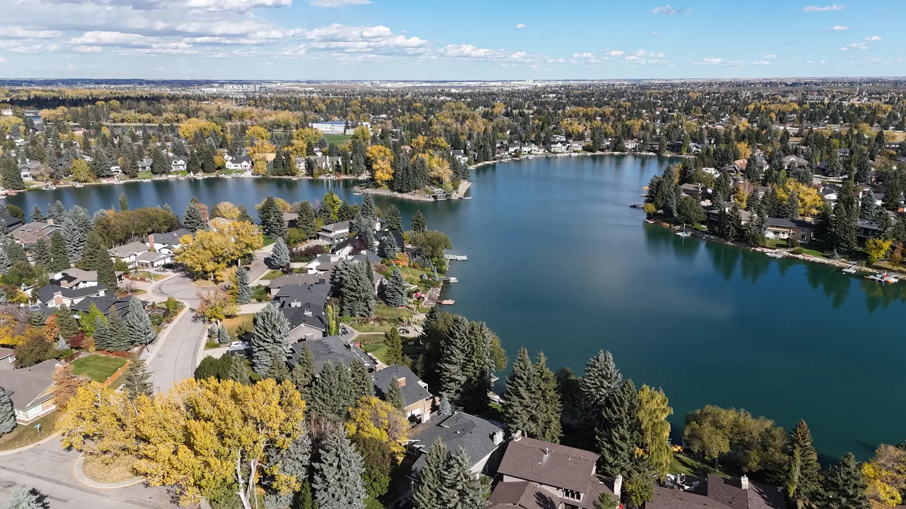 Aerial view of Lake Bonavista: lake-front homes with private docks, a quiet crescent and streets set back from the water